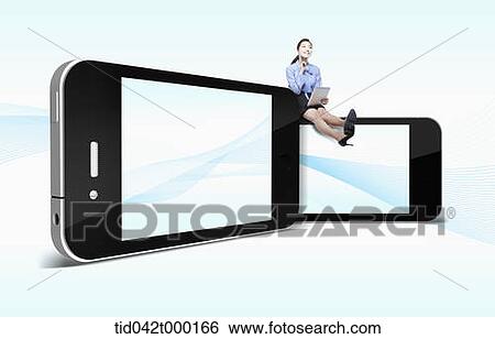 Stock Photograph - a woman sitting on a mobile phone. Fotosearch