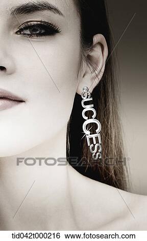 a woman wearing a earring with success sign View Large Photo Image Stock Photograph - a woman wearing a earring with success sign . Fotosearch
