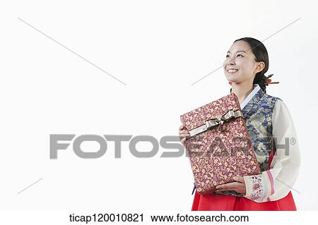 a woman wearing a Hanbok holding a present View Large Photo Image Stock Image - a woman wearing a Hanbok holding a present . Fotosearch