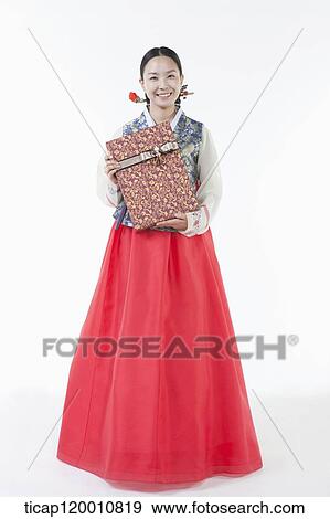 a woman wearing a Hanbok holding a present View Large Photo Image Stock Photo - a woman wearing a Hanbok holding a present . Fotosearch