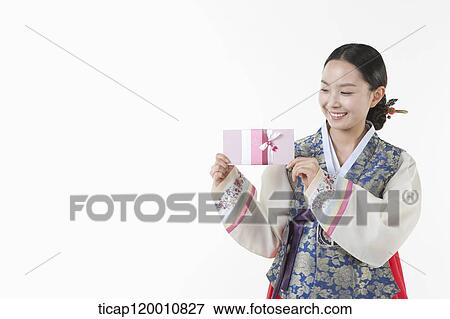 a woman wearing a Hanbok holding an envelope View Large Photo Image Stock Photo - a woman wearing a Hanbok holding an envelope . Fotosearch