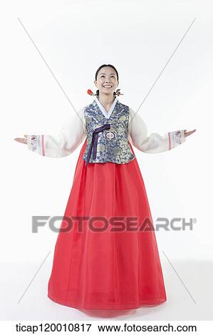 Stock Photo - a woman wearing a Hanbok spreading arms . Fotosearch