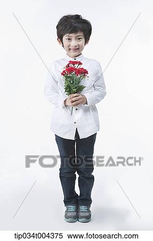 Stock Photography - a young boy holding a red flower. Fotosearch