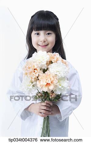 Stock Photograph - a young girl holding a bunch of flowers. Fotosearch