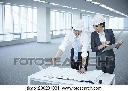 architect executives discussing with blueprints on a desk of an empty room View Large Photo Image Stock Image - architect executives discussing with blueprints on a desk of an empty room. Fotosearch