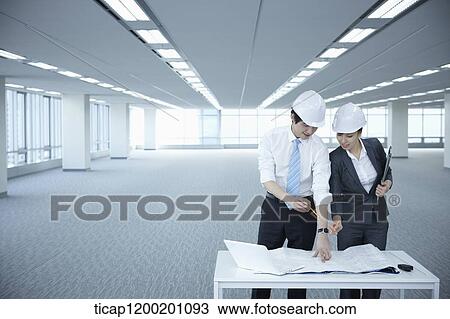 architect executives discussing with blueprints on a desk of an empty room View Large Photo Image Stock Image - architect executives discussing with blueprints on a desk of an empty room. Fotosearch