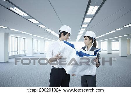 architect executives looking at blueprints in an empty room View Large Photo Image Picture - architect executives looking at blueprints in an empty room. Fotosearch