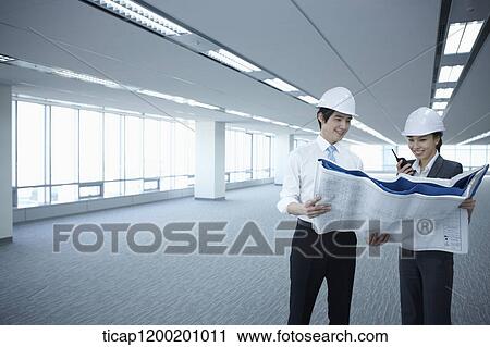 architect executives looking at blueprints in an empty room View Large Photo Image Stock Image - architect executives looking at blueprints in an empty room. Fotosearch