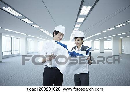 architect executives looking at blueprints in an empty room View Large Photo Image Stock Image - architect executives looking at blueprints in an empty room. Fotosearch