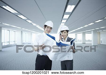 architect executives looking at blueprints in an empty room View Large Photo Image Stock Image - architect executives looking at blueprints in an empty room. Fotosearch