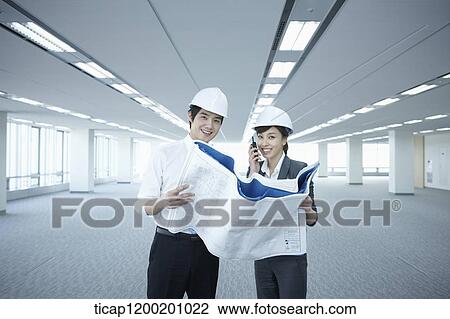 architect executives looking at blueprints in an empty room View Large Photo Image Stock Image - architect executives looking at blueprints in an empty room. Fotosearch