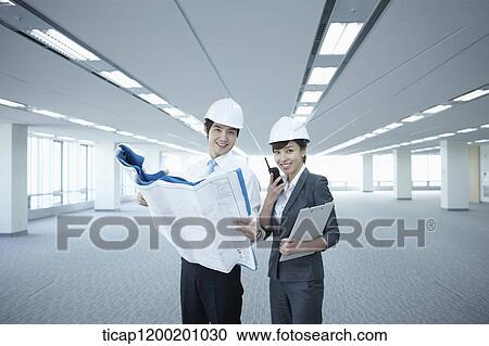 architect executives looking at blueprints in an empty room View Large Photo Image Stock Image - architect executives looking at blueprints in an empty room. Fotosearch