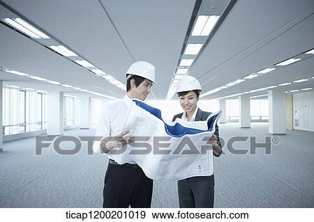 architect executives looking at blueprints in an empty room View Large Photo Image Stock Photo - architect executives looking at blueprints in an empty room. Fotosearch