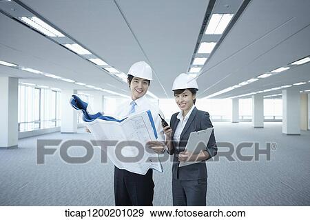 architect executives looking at blueprints in an empty room View Large Photo Image Stock Photo - architect executives looking at blueprints in an empty room. Fotosearch