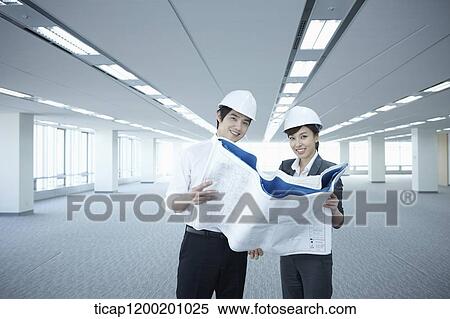architect executives looking at blueprints in an empty room View Large Photo Image Stock Photography - architect executives looking at blueprints in an empty room. Fotosearch
