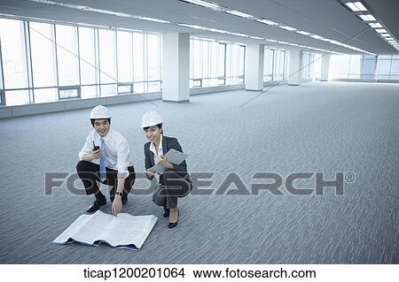 architect executives posing at camera in an empty room View Large Photo Image Picture - architect executives posing at camera in an empty room. Fotosearch