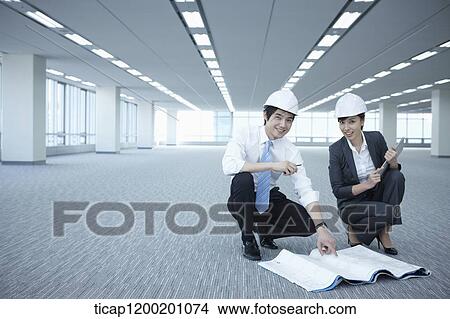 architect executives posing at camera in an empty room View Large Photo Image Picture - architect executives posing at camera in an empty room. Fotosearch
