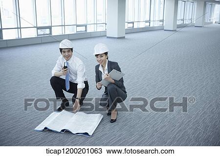 architect executives posing at camera in an empty room View Large Photo Image Stock Image - architect executives posing at camera in an empty room. Fotosearch