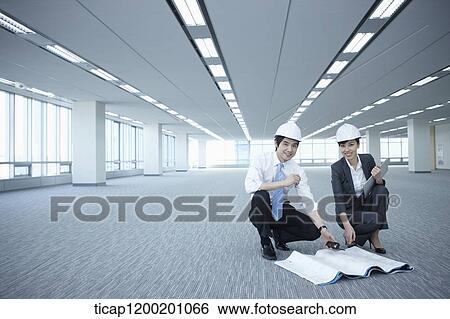 architect executives posing at camera in an empty room View Large Photo Image Stock Photograph - architect executives posing at camera in an empty room. Fotosearch