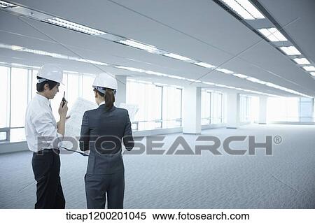 architect executives wearing construction helmets in an empty room View Large Photo Image Stock Photography - architect executives wearing construction helmets in an empty room . Fotosearch