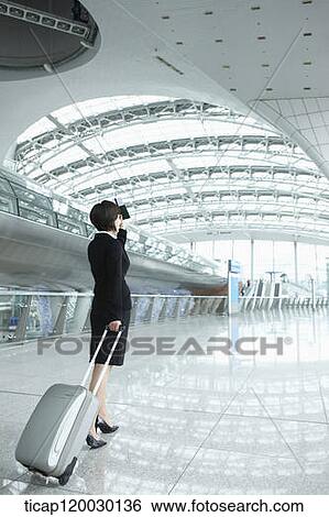 back of a businesswoman walking with luggage in Incheon airport View Large Photo Image Stock Photograph - back of a businesswoman walking with luggage in Incheon airport. Fotosearch