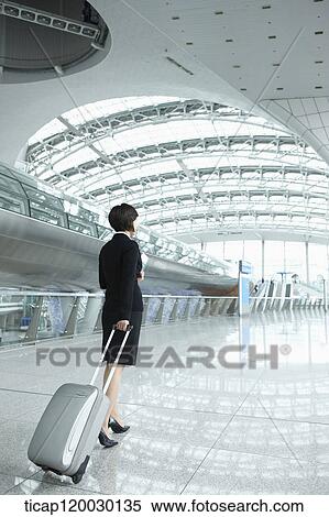 back of a businesswoman walking with luggage in Incheon airport View Large Photo Image Stock Photography - back of a businesswoman walking with luggage in Incheon airport. Fotosearch