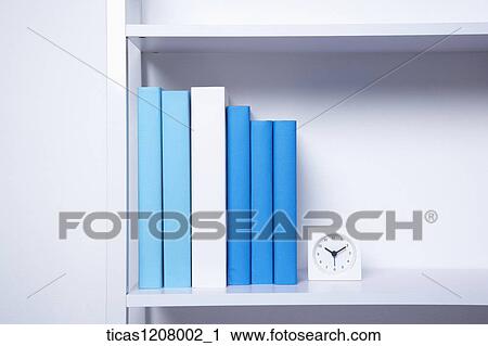 books and a clock on the book shelf View Large Photo Image Stock Image - books and a clock on the book shelf. Fotosearch