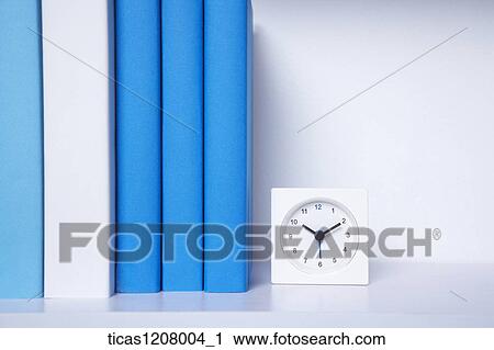 books and a clock on the book shelf View Large Photo Image Stock Image - books and a clock on the book shelf. Fotosearch
