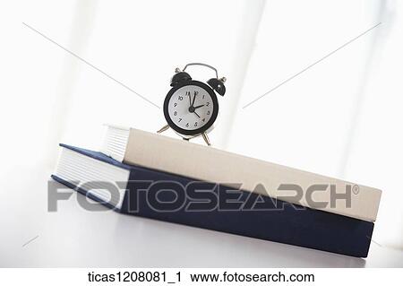 books and a clock on the table View Large Photo Image Stock Image - books and a clock on the table . Fotosearch