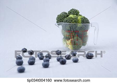 broccoli in a measuring cup with blueberries spread on the floor View Large Photo Image Stock Image - broccoli in a measuring cup with blueberries spread on the floor . Fotosearch