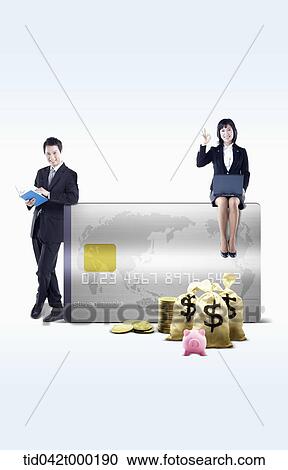 Stock Image - business people around a credit card . Fotosearch
