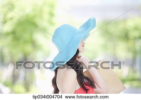 close up shot of a woman in turquoise hat looking sideways View Large Photo Image Picture - close up shot of a woman in turquoise hat looking sideways. Fotosearch