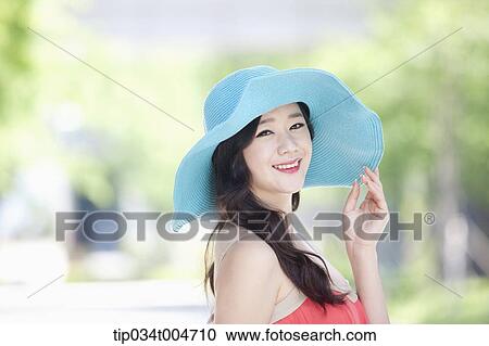 close up shot of a woman in turquoise hat smiling View Large Photo Image Stock Image - close up shot of a woman in turquoise hat smiling. Fotosearch