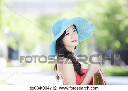 close up shot of a woman in turquoise hat smiling View Large Photo Image Stock Image - close up shot of a woman in turquoise hat smiling. Fotosearch