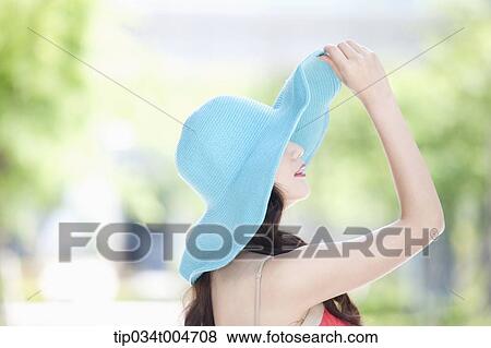 close up shot of a woman in turquoise hat looking sideways View Large Photo Image Stock Photo - close up shot of a woman in turquoise hat looking sideways. Fotosearch
