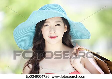 close up shot of a woman in turquoise hat holding shopping bags View Large Photo Image Stock Photograph - close up shot of a woman in turquoise hat holding shopping bags. Fotosearch