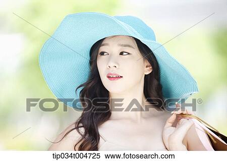 close up shot of a woman in turquoise hat holding shopping bags View Large Photo Image Stock Photography - close up shot of a woman in turquoise hat holding shopping bags. Fotosearch