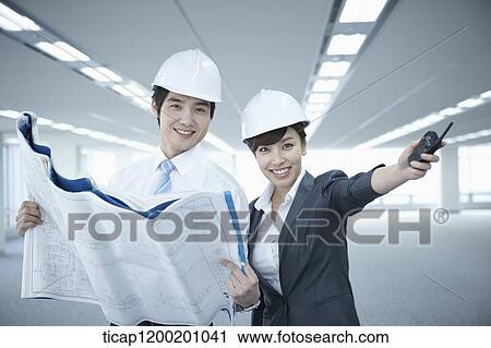 Stock Image - close up shot of architect executives in an empty room. Fotosearch