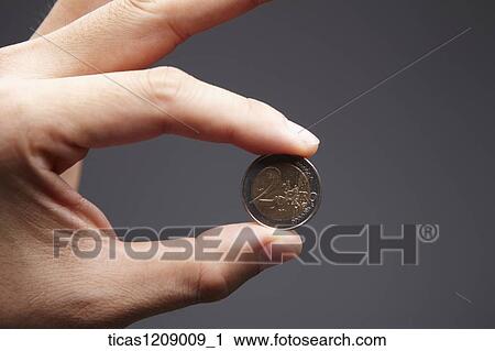 coin held by fingers View Large Photo Image Stock Image - coin held by fingers . Fotosearch