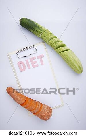 Stock Photography - diet written on a memo between chopped carrot and cucumber. Fotosearch