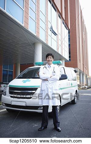 doctor standing in front of the ambulance with his arms folded View Large Photo Image Stock Image - doctor standing in front of the ambulance with his arms folded . Fotosearch