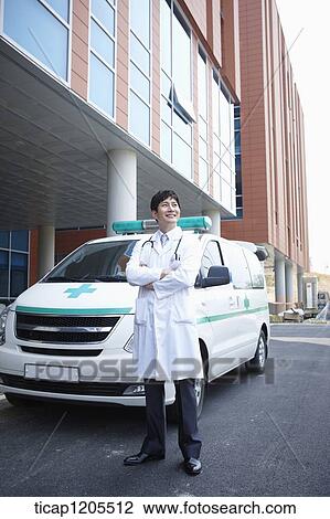 doctor standing in front of the ambulance with his arms folded View Large Photo Image Stock Image - doctor standing in front of the ambulance with his arms folded . Fotosearch