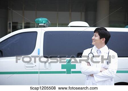 doctor standing in front of the ambulance with his arms folded View Large Photo Image Stock Photo - doctor standing in front of the ambulance with his arms folded . Fotosearch