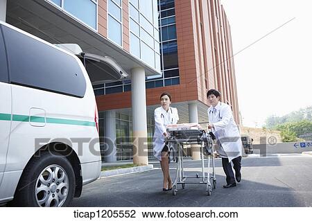 doctors moving a carrier ungently into the hospital View Large Photo Image Stock Image - doctors moving a carrier ungently into the hospital. Fotosearch