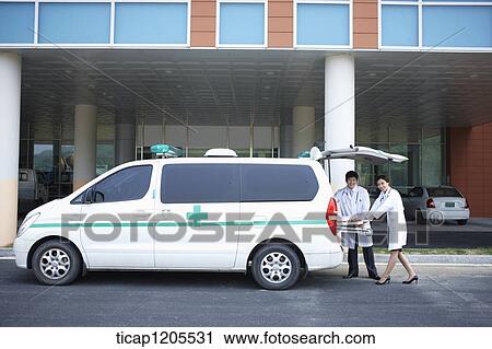doctors putting a carrier in the ambulance View Large Photo Image Stock Image - doctors putting a carrier in the ambulance. Fotosearch