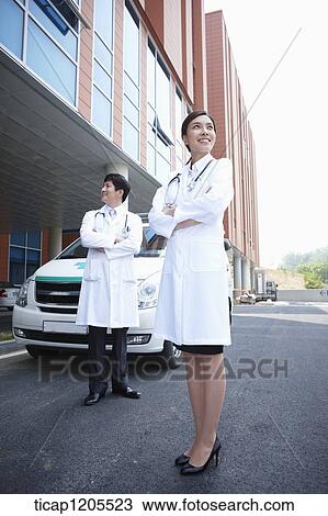 doctors standing in front of the ambulance with their arms folded View Large Photo Image Stock Image - doctors standing in front of the ambulance with their arms folded . Fotosearch