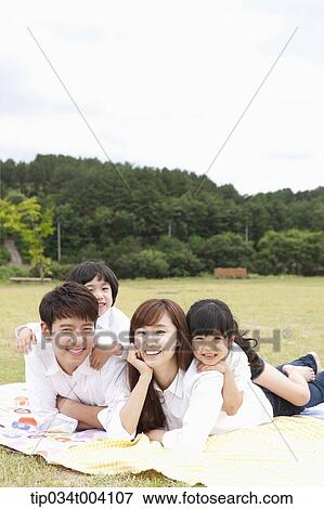 Stock Photo - family lying on their stomach . Fotosearch