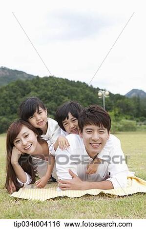 family lying on their stomach View Large Photo Image Stock Photograph - family lying on their stomach . Fotosearch