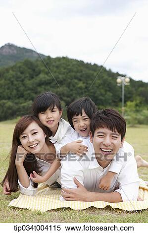 family lying on their stomach View Large Photo Image Stock Photography - family lying on their stomach . Fotosearch