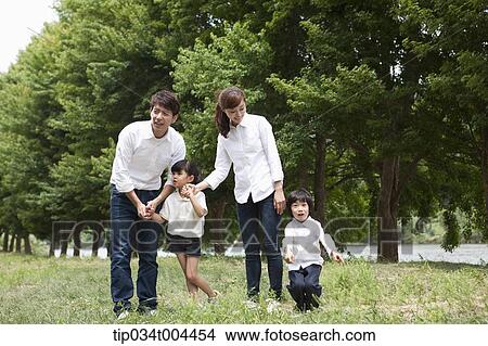 family posing on grass View Large Photo Image Picture - family posing on grass. Fotosearch